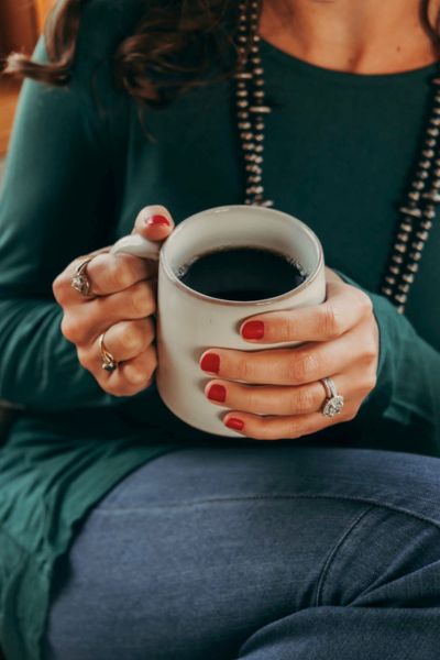 lady sitting with coffee having christmas at home