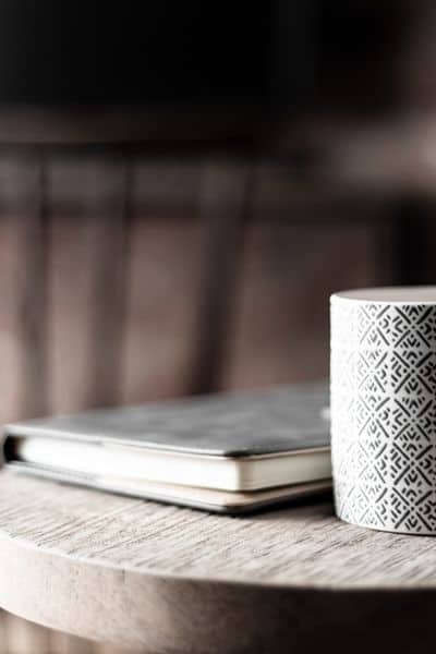 planner and cup on side table