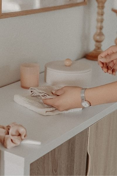 women decluttering a table top