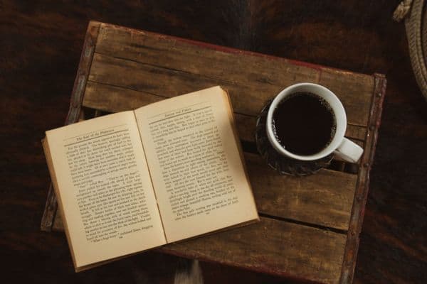 Cozy office wooden crate used as a side table with a book and coffee