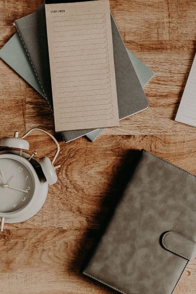 how to set realistic goals header image, planners and notepads