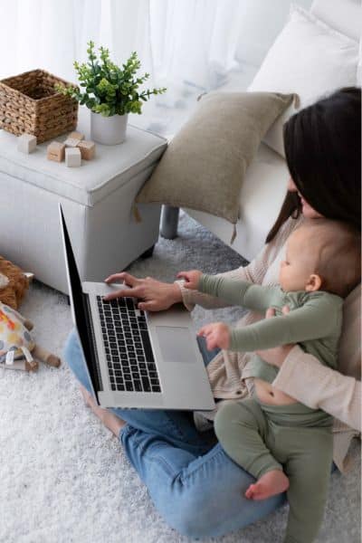 mom sitting with her baby at laptop