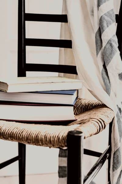 chair with books and a linin draped over it.